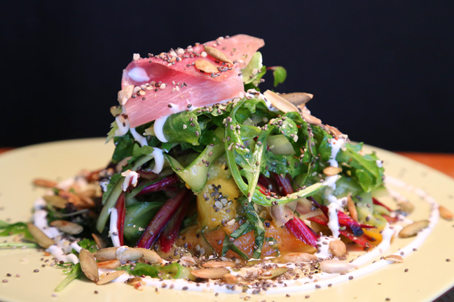 Peaches and Cream Salad  with arugula, celery, cuke, tomato, prosciutto, basil, toasted seeds, tarragon lime dressing